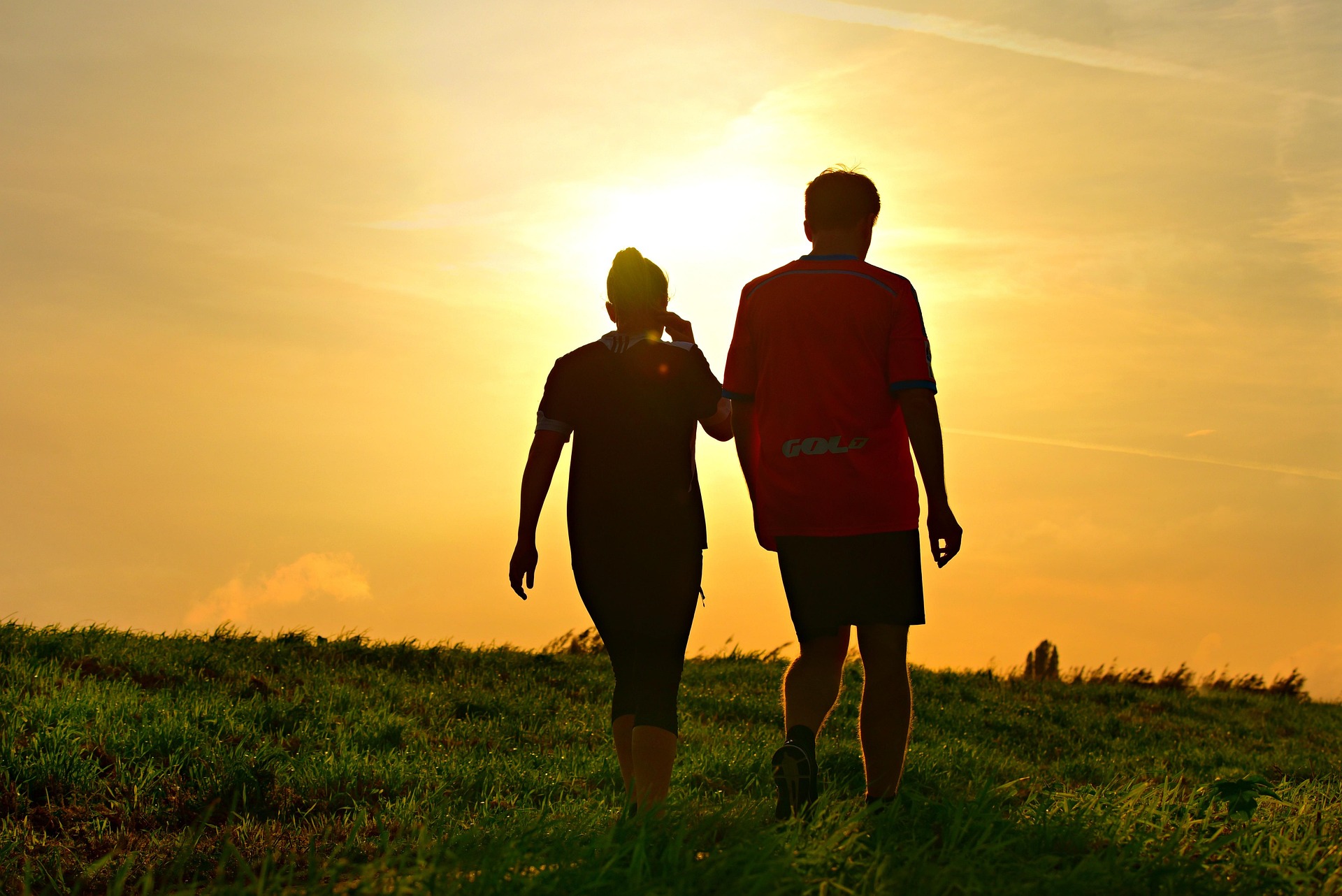 Person walking outdoors at different times of day for fitness