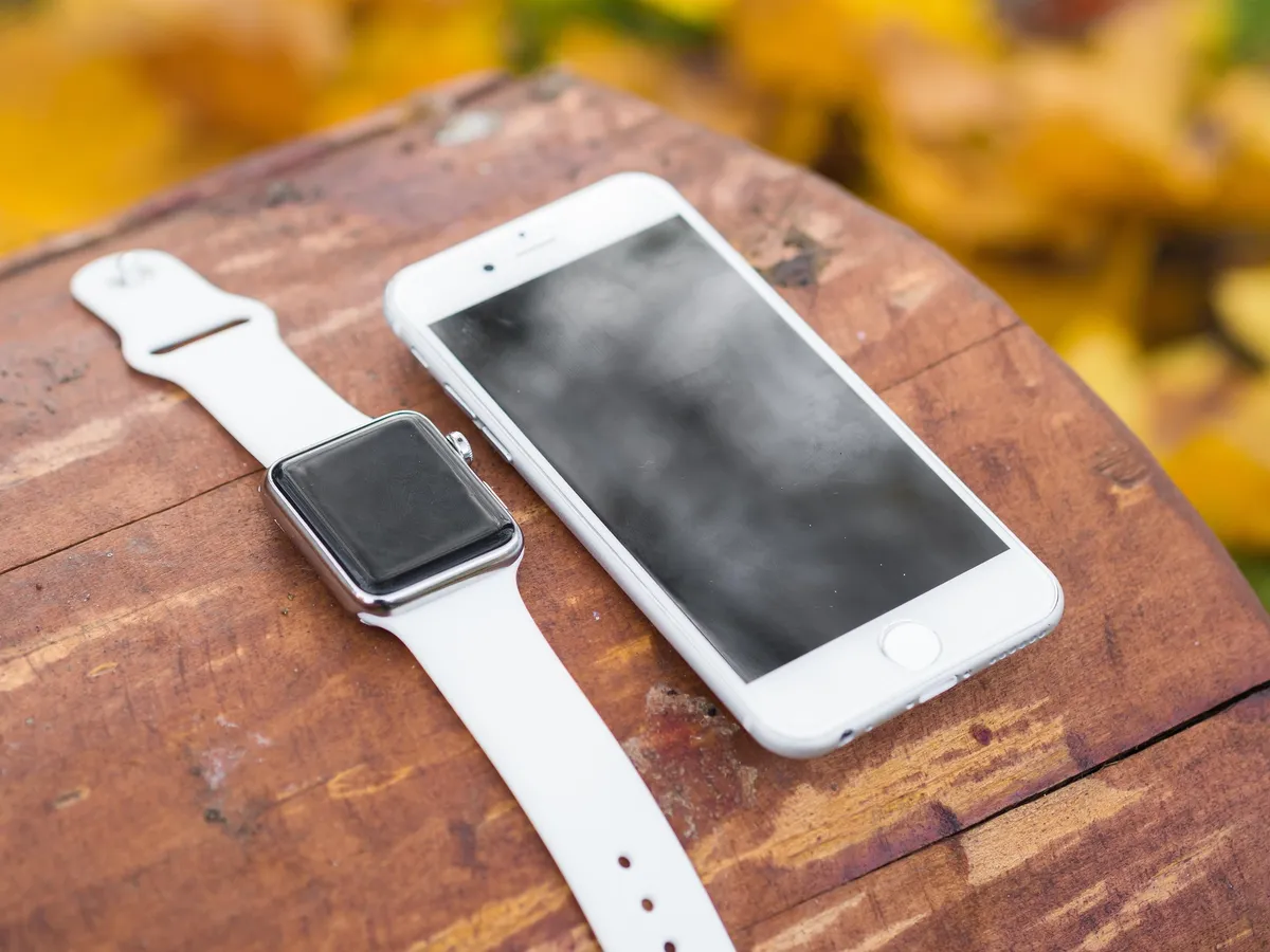 Person wearing Apple Watch while walking outdoors for step tracking
