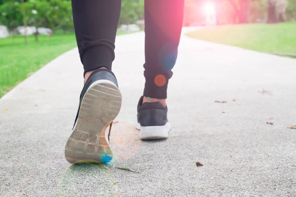 Person walking outdoors for daily step goal